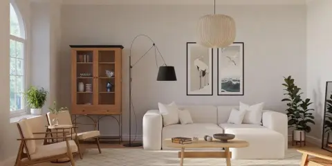 Ein Wohnzimmer im skandinavischen Design-Stil mit beiger Couch, Holzboden und einem Schrank.